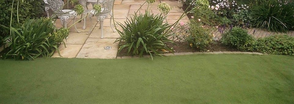 Stylish country garden with contemporary synthetic lawn